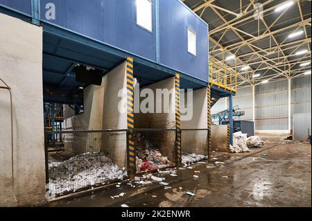 Accumulative hopper for plastic bags, paper, bottles. Separate sorting of household waste, waste sorting plant. Stock Photo