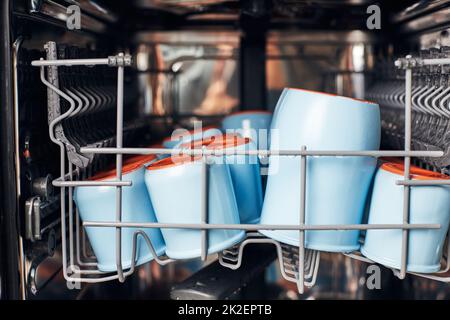 The process of washing yogrut jars in the dishwasher. Homemade yogurt making. Front view. Stock Photo