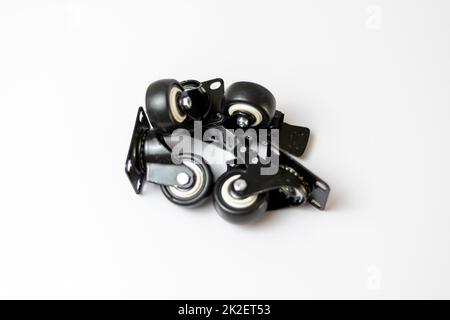 Black rubber tyre with lock function on a white isolated background with selective focus Stock Photo