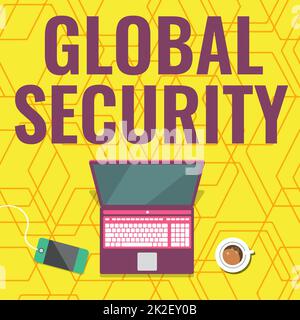 Affiche Global Security. Vue d'ensemble de l'entreprise protection du monde contre la guerre et autres menaces ordinateur portable reposant sur Une table à côté de la tasse à café et de l'usine montrant le processus de travail. Banque D'Images