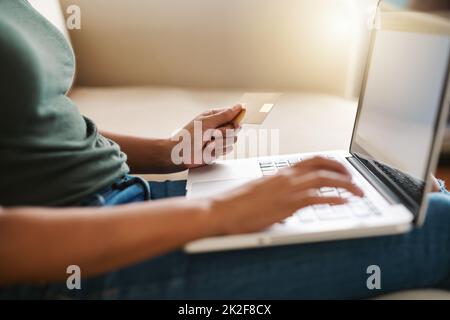 Travail le week-end. Photo courte d'une femme utilisant son ordinateur portable sur le canapé à la maison. Banque D'Images