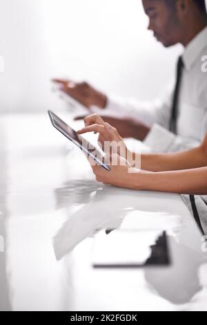 Better technology for better solutions. two businesspeople using their touchpads. Stock Photo