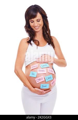 Whats in a name...A pregnant woman with post-it notes on her stomach with a selection of baby names. Stock Photo