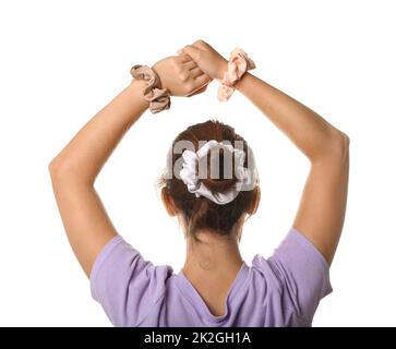 Woman with bun hairstyle and different silk scrunchies on white background Stock Photo