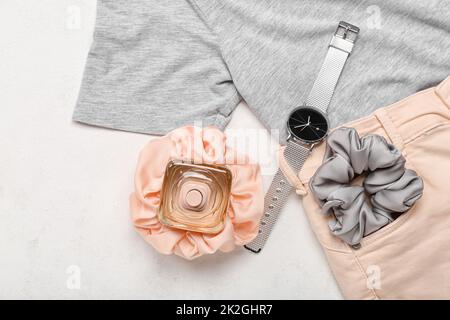 Female clothes, scrunchies, perfume bottle and wristwatch on white background Banque D'Images
