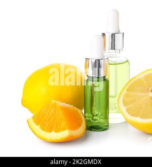 Bottles of citrus serum and fruits isolated on white background Banque D'Images