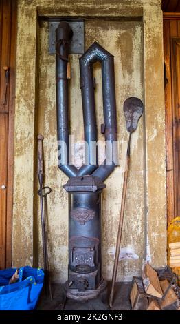 Angelsberg, Sweden - May 28, 2022: An old cast iron oven with old tools for warming up Stock Photo