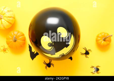 Composition with Halloween decor and pumpkins on yellow background Stock Photo