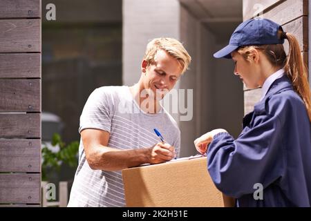 Customer satisfaction. Signed, sealed and delivered. a courier making a delivery to a happy customer. Stock Photo