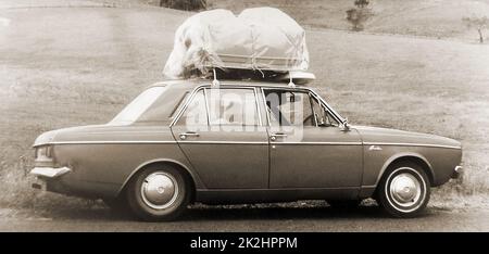 1971. An Australian General Motor's Holden with its roof rack fully loaded. The firm began as J. A. Holden & Co., a saddlery business in Adelaide in 1852 started by James Alexander Holden who had emigrated to South Australia from Walsall,  England. Stock Photo