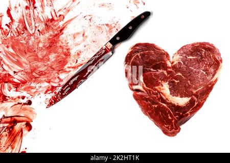Viande fraîche brute en forme de coeur, de couteau et de sang Banque D'Images