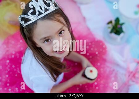 Chaque petite fille devrait se sentir comme une princesse. Portrait d'une petite fille habillée comme une princesse ayant un pique-nique à l'extérieur. Banque D'Images