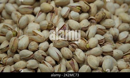 Pistaches, pistacia vera, fruits secs. Gros plan pile de haricots il a une coquille de noix blanche sèche et dure de Pistachio Banque D'Images