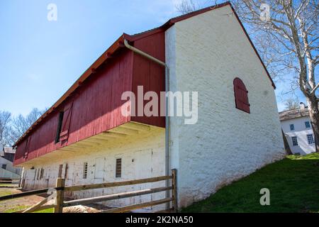 Grange coloniale américaine en pierre blanchie à la chaux avec boiseries rouges Banque D'Images