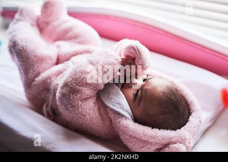 Bonjour petite fille, bienvenue au monde. Photo d'une adorable petite fille sur un poste de changement de couches à la maison. Banque D'Images