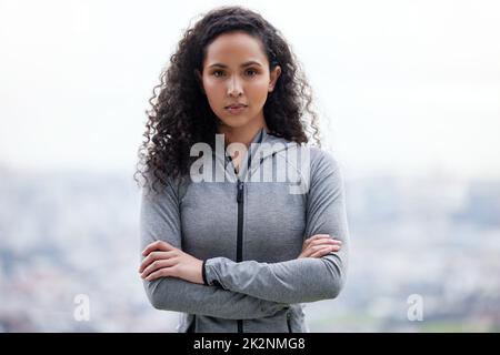 Je suis prêt à apporter quelques changements nécessaires dans ma vie. Photo d'une belle jeune femme debout avec ses bras croisés pendant une course. Banque D'Images