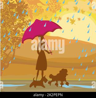 Fille qui marche avec ses chiens en paysage d'automne. Banque D'Images