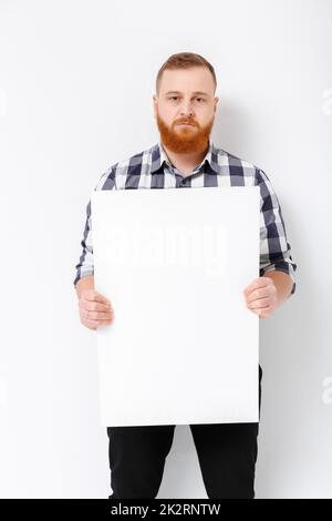 Homme avec barbe holding big white card. Banque D'Images