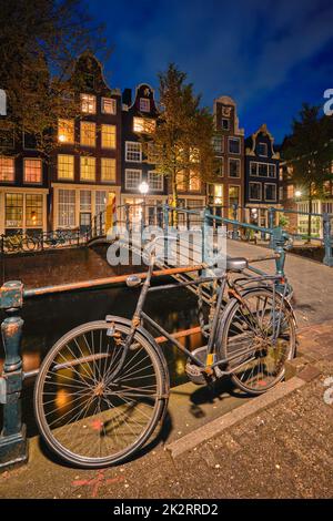Amsterdam canal, pont et maisons de la cité médiévale dans la soirée Banque D'Images