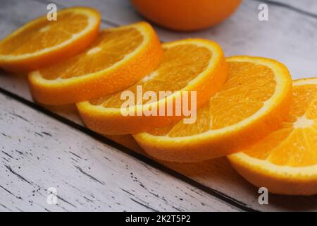 Tranches d'orange empilées les unes sur les autres sur une table en bois. Banque D'Images