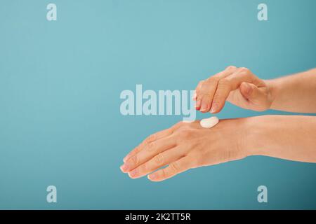 Récolte femelle appliquant de la crème biologique sur les mains Banque D'Images