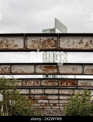 Riveted steel girders above Castlefield Viaduct with Beetham Tower in the distance. Manchester. Stock Photo