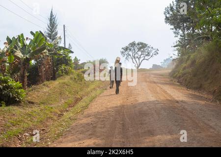 Des enfants de différents âges essayaient de recueillir de l'eau potable en Ouganda Banque D'Images