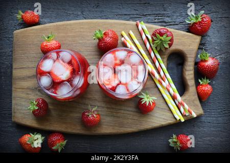 Boisson rafraîchissante d'été avec fraise dans des verres sur la table en bois vintage. Vue de dessus Banque D'Images