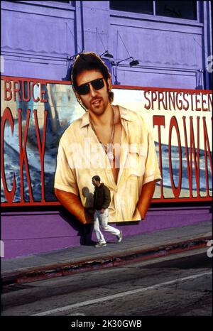 Un jeune homme passe devant un panneau d'affichage Bruce Springsteen pour Lucky Town sur le côté du Whisky A Go Go sur le Sunset Strip à Los Angeles, CA, 1992 Banque D'Images