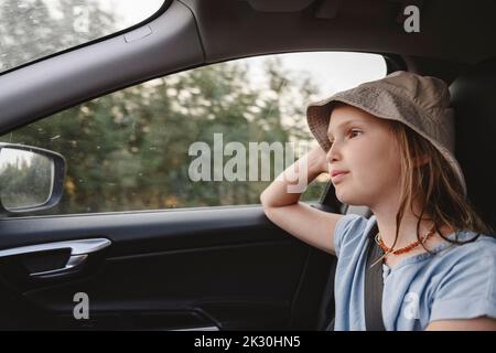 Cute girl wearing hat traveling in car Stock Photo