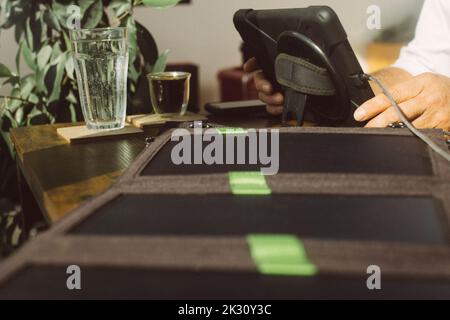 Businessman using tablet PC being charged by photovoltaic solar panel Stock Photo