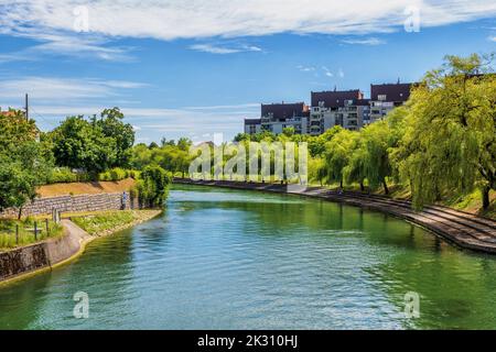 Slovenia, Ljubljana, Ljubljanica river stretching along Trnovski Pristan Embankment in summer Stock Photo