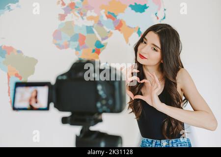 Young influencer making heart shape with hands in front of camera Stock Photo