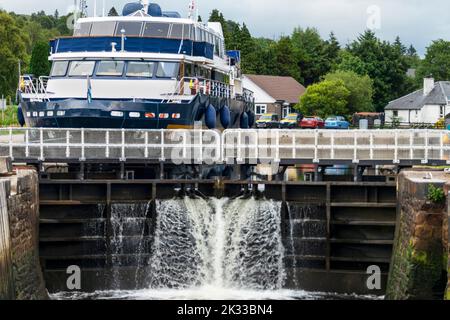 Début du canal calédonien, près de fort William et Ben Nevis, eau qui coule à travers les portes d'écluse, avec petit navire écossais derrière les portes, attendant Banque D'Images