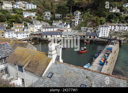 The Harbour at the fishing village of Polperro in south Cornwall at Low tide. Seen from the Fish Quay with the Heritage Museum and Tea room in the dis Stock Photo