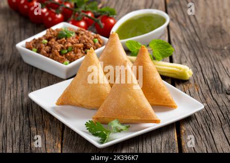Samosha.Indian Delicious Deep Fried Breakfast Samosa aussi connu comme Samoosa isolé sur texture de bois fond Banque D'Images