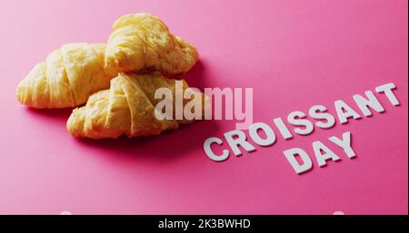 Image de gros plan des croissants et du texte croissant du jour sur fond rose Banque D'Images
