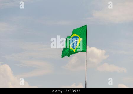 Goias, Brésil – 25 septembre 2022 : drapeau du Brésil volant et flottant dans le vent avec ciel nuageux en arrière-plan. Banque D'Images