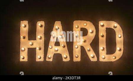 Panneau lumineux rigide avec ampoules de style rétro au mur foncé Banque D'Images