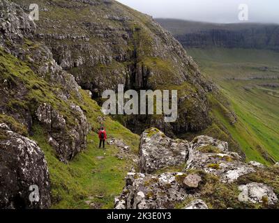 Walker sur le chemin de Hvalba, Suðuroy, Faroes Banque D'Images