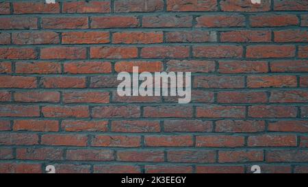 mur pavé rouge avec joints de cimentation gris Banque D'Images