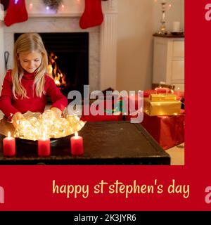 Composition du texte du jour de St stephen et de la fille caucasienne à noël par foyer Banque D'Images