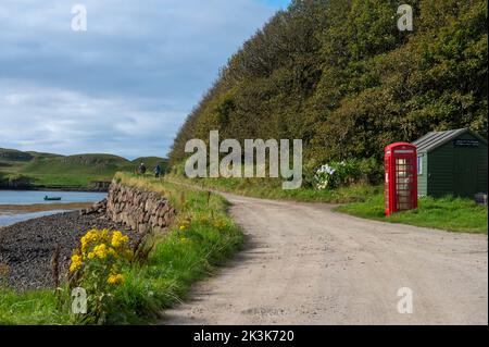 Septembre 2022: Île de Canna, Inner Hebrides, Écosse le bureau de poste et l'ancienne boîte téléphonique rouge sur la route côtière Banque D'Images