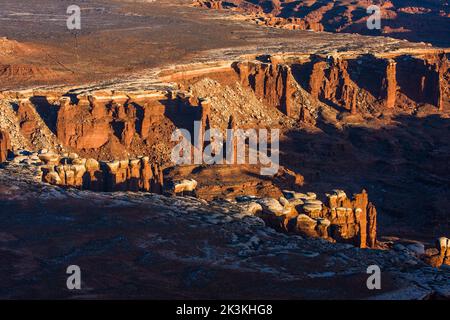 Formations rocheuses de schiste d'orgue Rock avec bouchons en grès White Rim dans Monument Basin, Parc national de Canyonlands, Utah. Banque D'Images