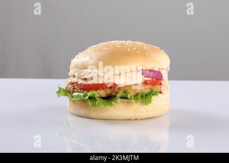 HAMBURGER CROUSTILLANT AUX PATTY DE POULET AU CHEESY SUR FOND BLANC Banque D'Images