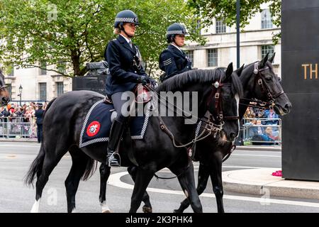 Les officiers de police des femmes montées se trouvent à côté du monument des femmes de la Seconde Guerre mondiale à Whitehall, Londres, Royaume-Uni. Banque D'Images