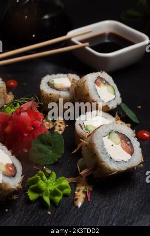 délicieux petits pains à sushis avec saumon et fromage à la crème dans des chips de thon Banque D'Images