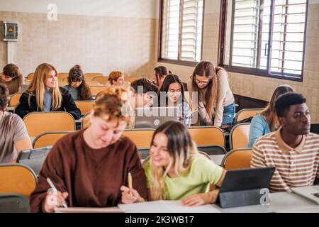 Classe universitaire où l'enseignant explique personnellement la leçon à un étudiant Banque D'Images