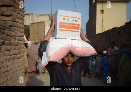 Peshawar, Pakistan. 22nd septembre 2022. Les personnes touchées par les inondations reçoivent une aide de secours distribuée par la Fondation Al Khidmat dans le district de Nowshera, dans le village de Garhi Momin, dans la province de Khyber Pakhtunkhwa à Peshawar, au Pakistan, le 22 septembre 2022. (Photo de Hussain Ali/Pacific Press/Sipa USA) crédit: SIPA USA/Alay Live News Banque D'Images