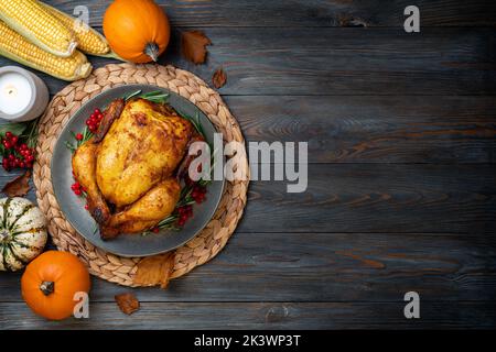 Thanksgiving. Poulet rôti ou dinde pour un dîner festif sur une table en bois. Concept de Thanksgiving. Copier l'espace Banque D'Images
